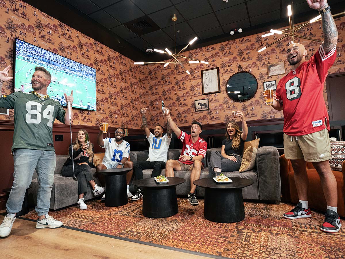 Group in football jerseys cheering